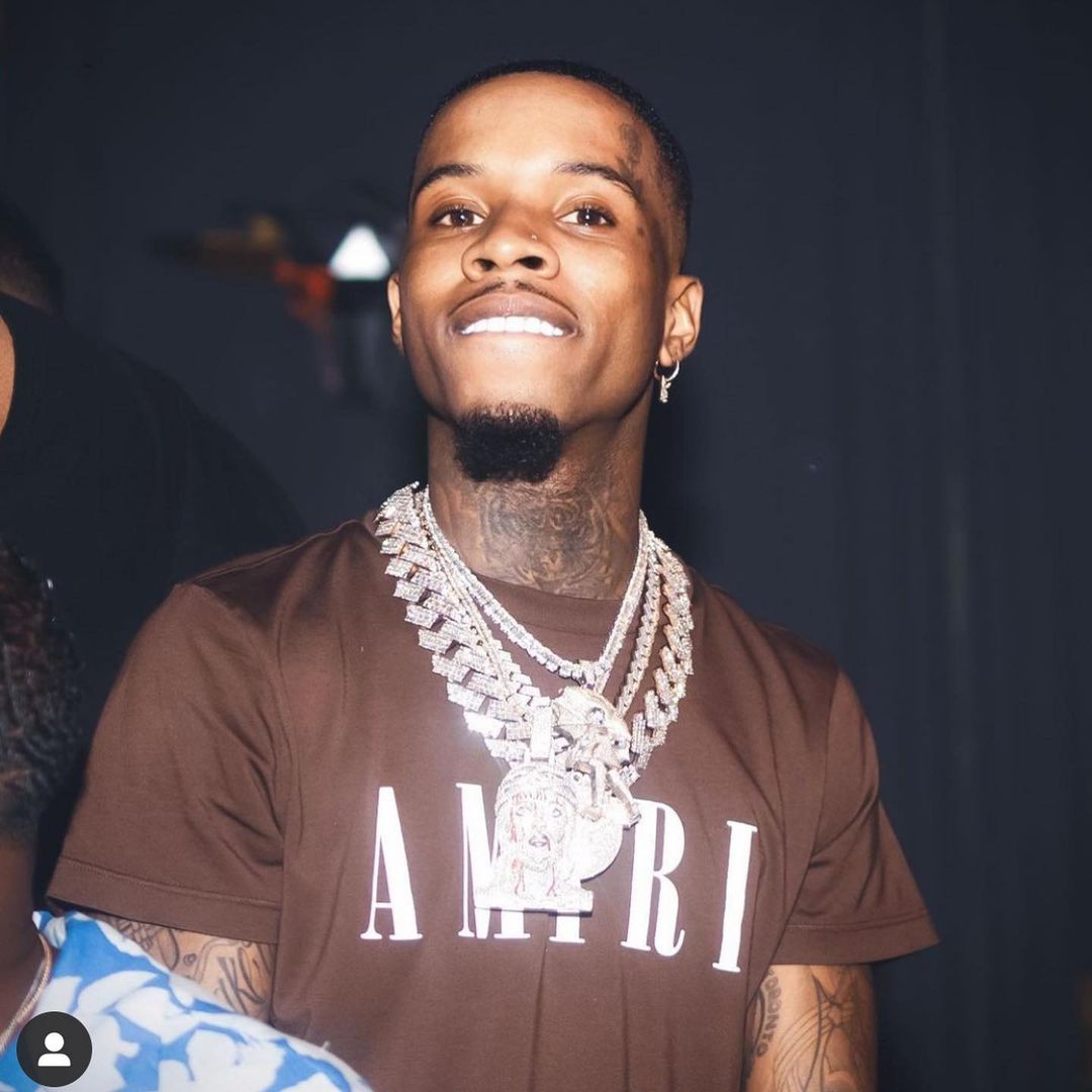 Tory Lanez in brown t-shirt with silver chain around neck