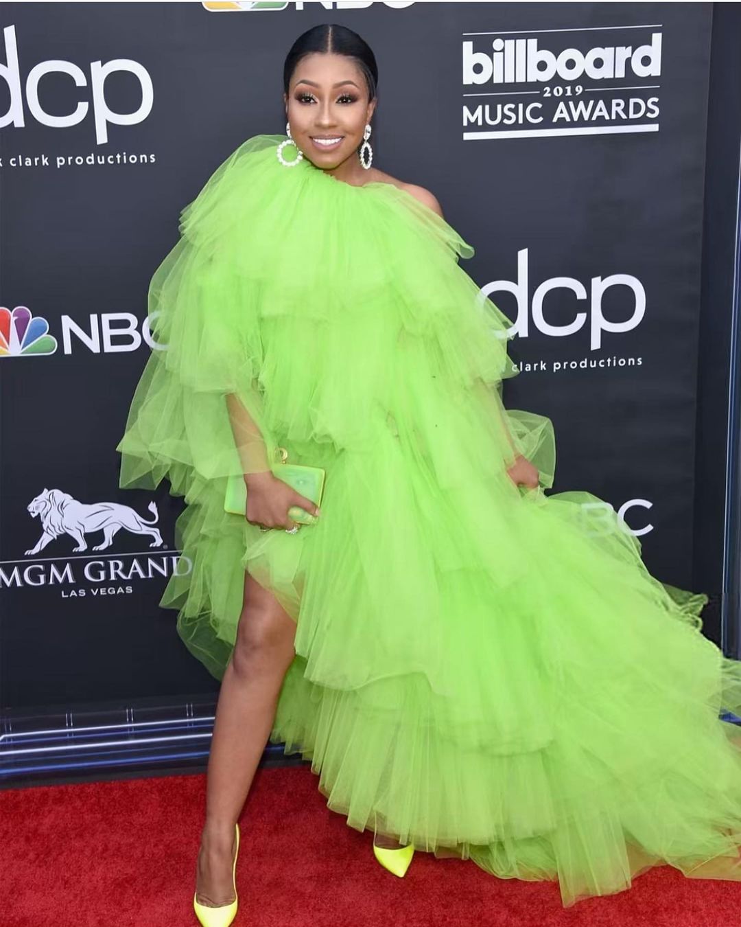 Yung Miami at Billboard 2019 music awards in parrot green dress