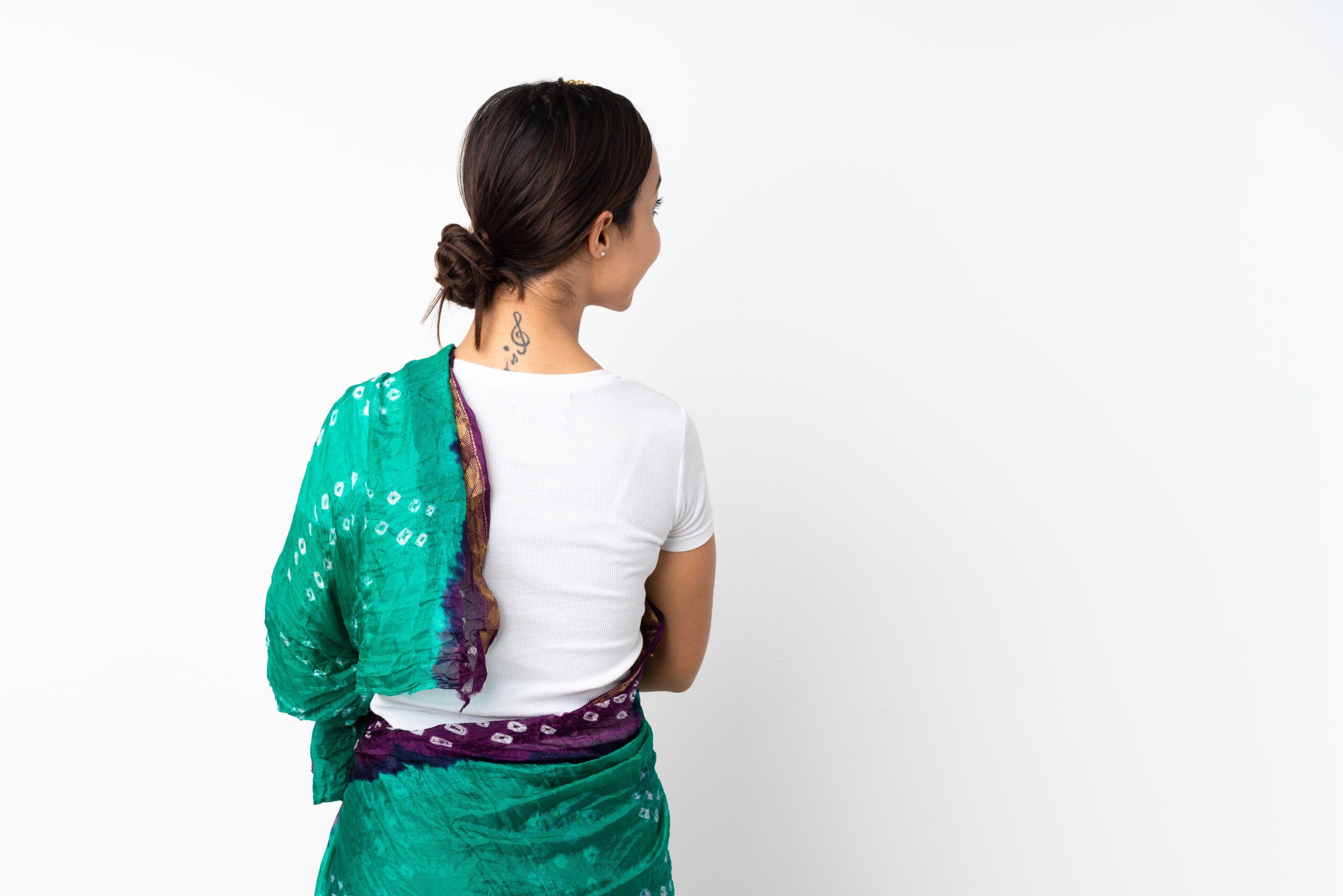 Woman giving back pose in a saree 