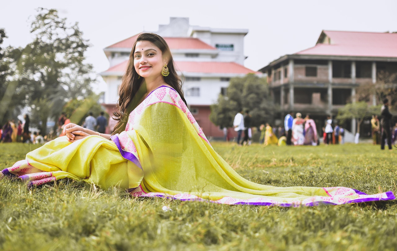 Woman sitting on the ground in saree