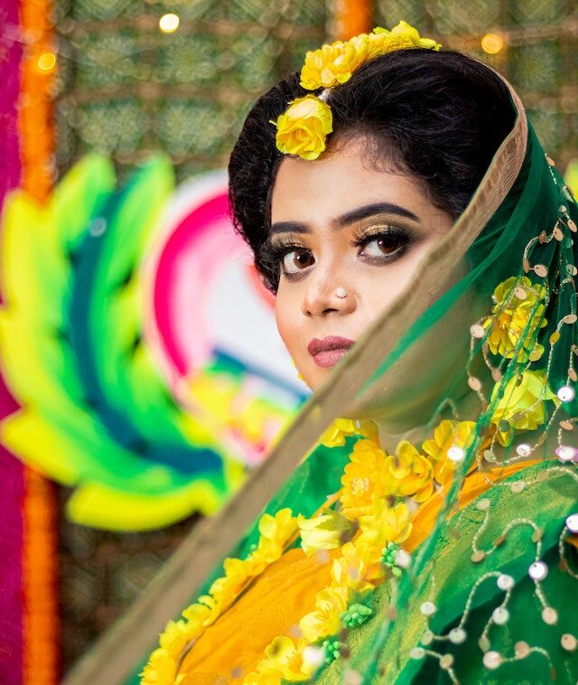 woman adjusting pallu of her green saree