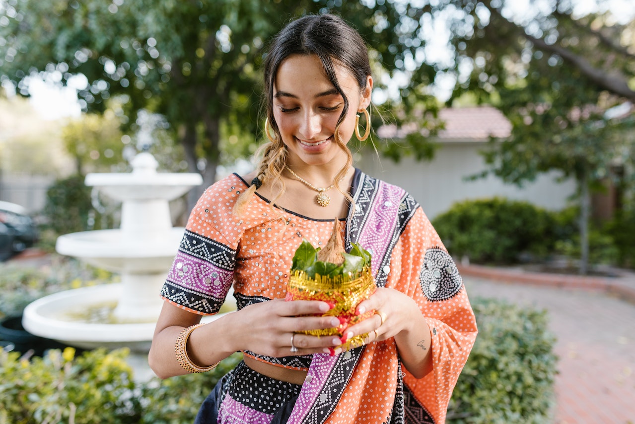 Young woman looking down in a saree 