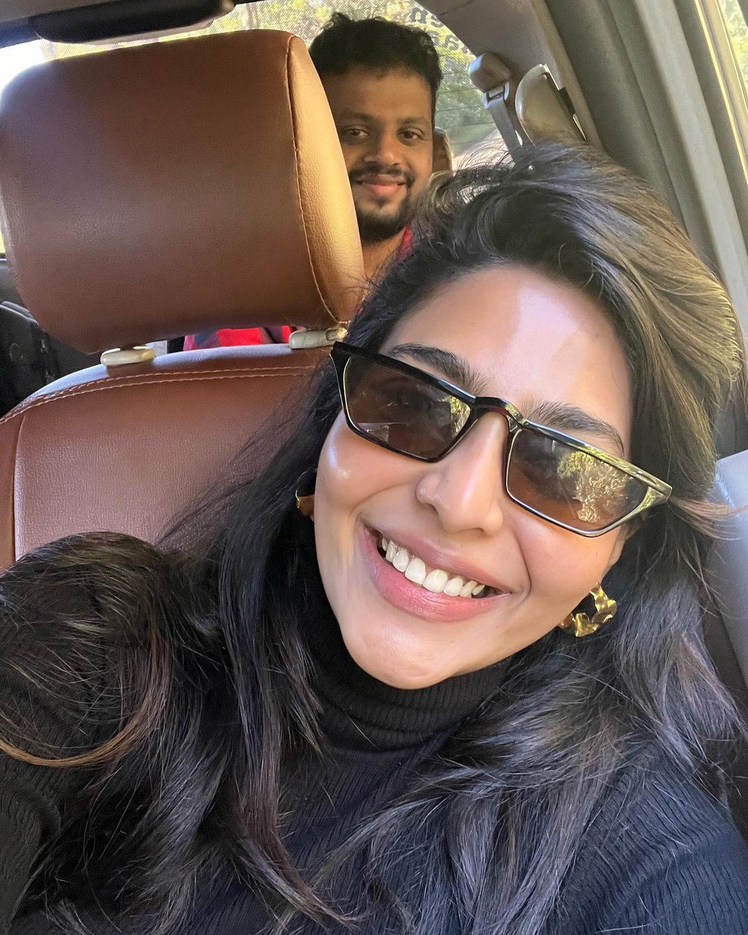 Aishwarya Lakshmi traveling in a car
